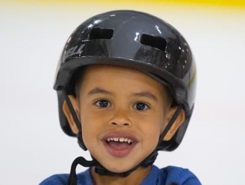Smiling child skater wearing a helmet