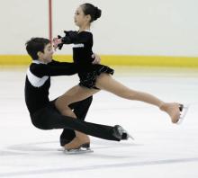 A pair of young ice skaters
